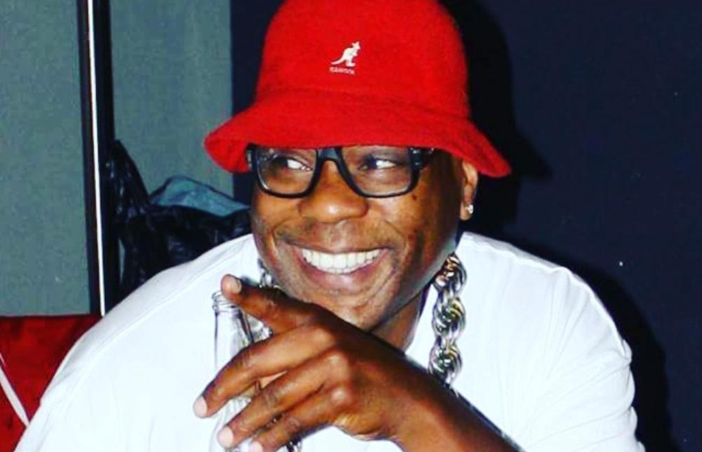 FUN DMC — DJ and karaoke host smiling in red bucket hat
